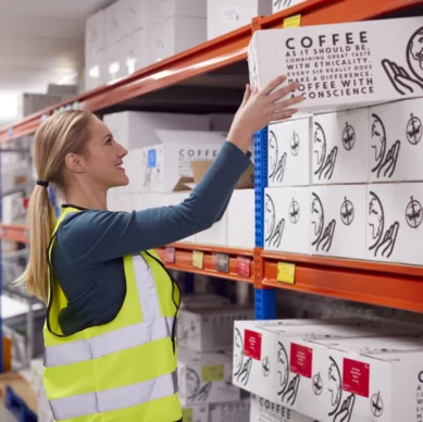 female-worker-inside-busy-warehouse-putting-box-on-2024-10-20-22-14-10-utc